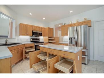 Bright kitchen with ample cabinet space, stainless steel appliances and a functional island at 2608 S Troy Ct, Aurora, CO 80014