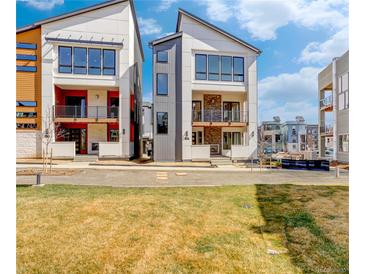 Modern townhomes feature large windows and private balconies in a community setting at 1778 Peak Loop, Broomfield, CO 80023