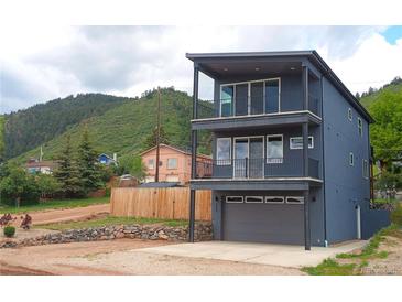 Modern two-story home with sleek balconies, gray exterior, and mountain views at 260 Upper Glenway Rd, Palmer Lake, CO 80133