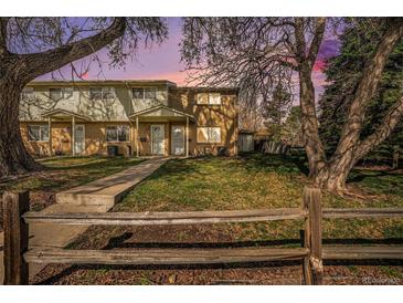 Charming townhome featuring brick and siding with a well-maintained front yard and a cozy, covered porch at 4509 Everett St, Wheat Ridge, CO 80033