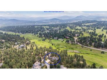 Beautiful aerial view of the property backing to HOA open space and trail at 2023 Mammoth Ct, Evergreen, CO 80439