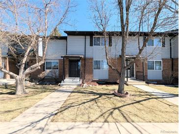 Inviting townhome exterior with brick accents, tidy lawn, and a walkway to the front door at 3061 W 92Nd Ave # 2D, Westminster, CO 80031