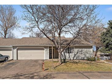 Charming single-story home featuring an attached garage and well-maintained front yard at 14273 E Marina Dr, Aurora, CO 80014