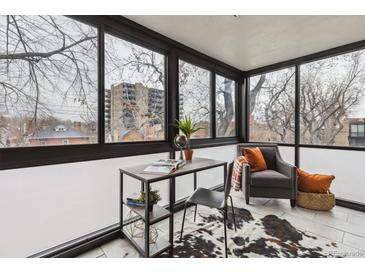 Bright sun room with desk area, comfortable chair and large windows with beautiful views at 1050 N Corona St # 316, Denver, CO 80218