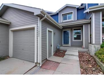 Charming home exterior featuring a well-maintained garage and inviting front door at 11009 Gaylord. St, Northglenn, CO 80233