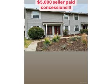 Attractive exterior of a two-story townhome with landscaping at 1920 S Oswego Way, Aurora, CO 80014