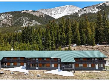 Charming two-story condo with wooden accents, balcony, and scenic mountain views at 4192 Highway 9 # 3, Breckenridge, CO 80424