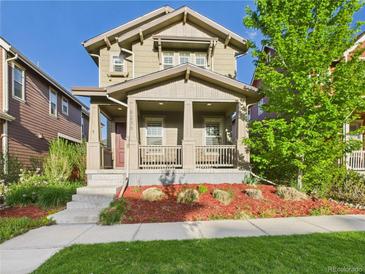 Charming two-story home with inviting front porch and well-maintained landscaping and nice curb appeal at 9236 E 52Nd Dr, Denver, CO 80238