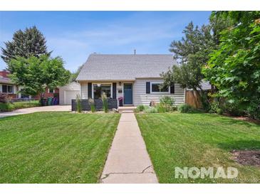 Charming home with a well-maintained front yard, inviting walkway, and lovely curb appeal at 2965 S Gilpin St, Denver, CO 80210