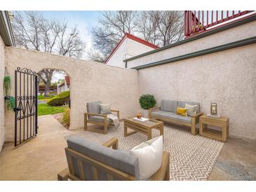 Inviting outdoor patio featuring comfortable seating and a decorative rug for relaxing and entertaining at 1321 Madero St, Broomfield, CO 80020