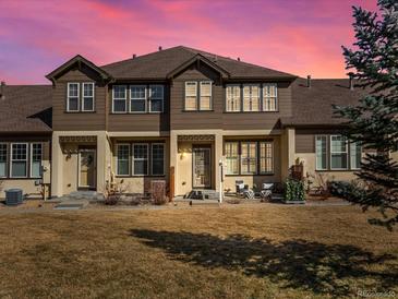 Charming multi-story home featuring a well-maintained lawn and a welcoming front entrance with chairs at 5833 S Van Gordon Ln, Littleton, CO 80127