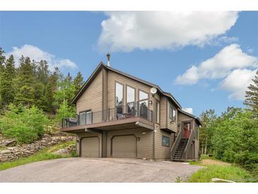 Inviting two-story home featuring a spacious balcony, two-car garage and well-maintained landscaping at 1758 Sinton Rd, Evergreen, CO 80439