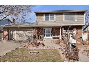 Charming two-story home with a well-manicured front yard and attached two-car garage at 13957 E Louisiana Pl, Aurora, CO 80012