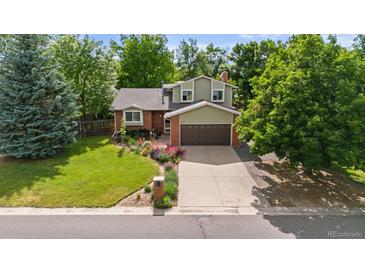 Charming two-story home with a brick facade, lovely landscaping and a two car garage at 5971 Windy St, Golden, CO 80403