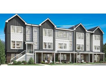 Modern townhouse exterior featuring a stylish combination of gray siding and brick accents at 694 Saddle Dr, Erie, CO 80516