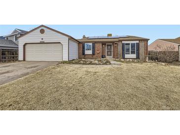 Ranch style home with attached garage and solar panels at 4351 E 115Th Pl, Thornton, CO 80233