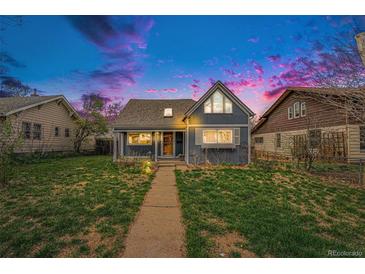 Charming home featuring a well-kept lawn, inviting pathway and a cozy covered front porch at 3921 S Acoma St, Englewood, CO 80110