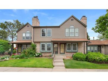 Charming townhome with brick and siding exterior, well-manicured lawn, and inviting entrance at 17151 E Stanford Ave # B, Aurora, CO 80015