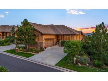 Charming single-Gathering home featuring a concrete driveway, an attached garage and mature trees at 4336 Chateau Ridge Rd, Castle Rock, CO 80108