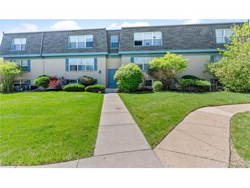 Inviting two-story condo featuring a lush lawn and charming blue accents at 9100 E Girard Ave # 7, Denver, CO 80231
