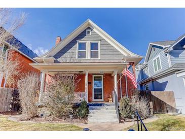 Charming brick home featuring a cozy front porch, well-maintained landscaping, and classic architectural details at 515 S Grant St, Denver, CO 80209