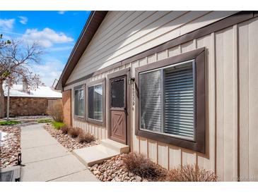 Charming home exterior features a quaint entrance and rock landscaping at 16035 E Ithaca Pl # D, Aurora, CO 80013