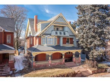 Beautiful exterior view of a charming multi-story home with a lovely porch and classic architectural details at 1435 Vine St # 2, Denver, CO 80206