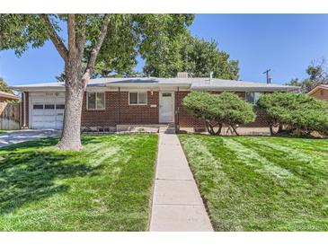 Charming brick home with a well-manicured lawn and a welcoming walkway at 7020 Canosa Ct, Westminster, CO 80030