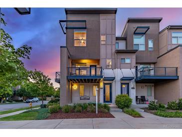 Charming three-story townhouse featuring a private balcony and modern design at 10305 Martin Luther King Blvd, Denver, CO 80238