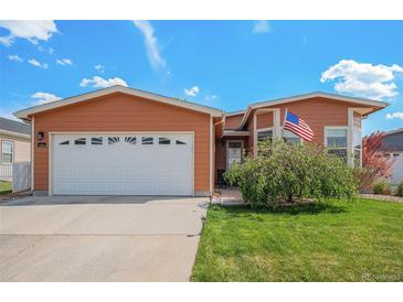 Charming single-Gathering home with a two-car garage, manicured lawn, and mature landscaping at 7930 Larkspur Cir, Frederick, CO 80530