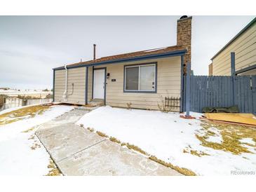 Cute house exterior, snow on the ground, walkway to the front door at 974 S Zeno Way, Aurora, CO 80017