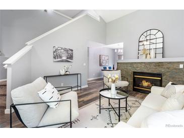 Bright living room with fireplace, hardwood floors and soaring ceilings at 12666 Davis St, Broomfield, CO 80020