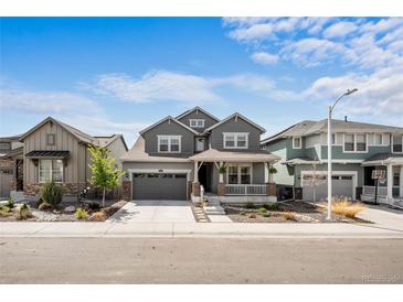 Charming two-story home with a covered porch and well-manicured landscaping at 8109 Mount Ouray Rd, Littleton, CO 80125