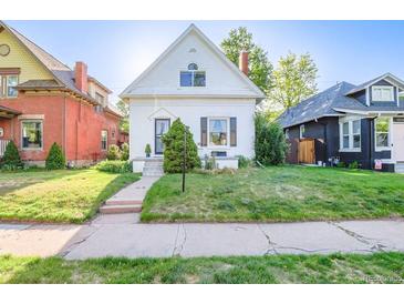 Charming home featuring a well-manicured front lawn, quaint architecture, and lovely curb appeal at 1006 S Emerson St, Denver, CO 80209