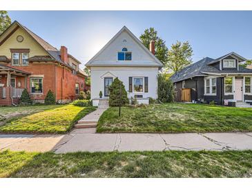 Charming white home with a well-maintained front yard and walkway at 1006 S Emerson St, Denver, CO 80209