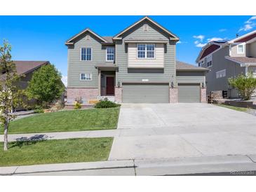 Charming two-story home with a well-maintained lawn and a three-car garage at 12210 Pine Post Dr, Parker, CO 80138