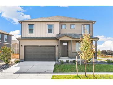 Two story home featuring a 2-car garage, a covered porch and a well-maintained lawn at 4338 Cattle Cross Trl, Castle Rock, CO 80104