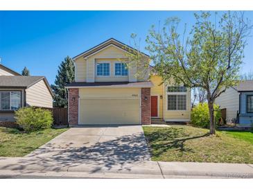 Charming two-story home featuring a spacious front yard and inviting red front door at 4965 Collinsville Pl, Highlands Ranch, CO 80130