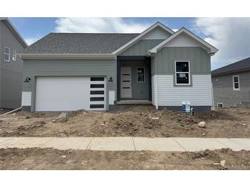 Charming single-story home with a modern garage door and stylish exterior paint at 138 S Seacrest St, Golden, CO 80401