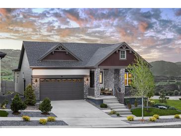 Charming single-Gathering home featuring stone accents, a two-car garage, and a welcoming front porch with mountain views at 138 S Seacrest St, Golden, CO 80401