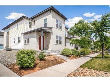 Modern two-story home with clean lines, light gray siding, and well-maintained landscaping at 16019 E Elk Dr, Denver, CO 80239
