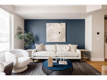 Bright living room features a comfy sofa and stylish coffee table at 1836 Grove St # 107, Denver, CO 80204