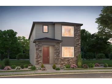 Charming two-story home with stone accents and a well-manicured front yard, perfect for curb appeal at 6322 N Malaya St, Aurora, CO 80019