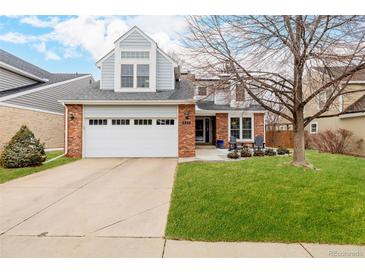 Charming two-story home with a well-manicured lawn, attached two car garage, and inviting curb appeal at 8827 Cactus Flower Way, Highlands Ranch, CO 80126