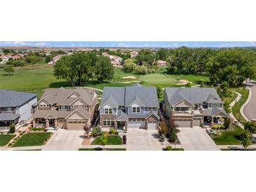 Beautiful home exterior backing to golf course featuring an attached garage and well-maintained landscaping at 4960 Malaya St, Denver, CO 80249