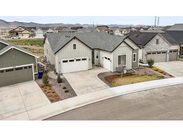 Inviting two-story home featuring a spacious two-car garage, manicured landscaping, and a charming front entrance at 8985 Chalk Creek Pl, Littleton, CO 80125