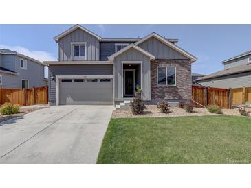 Charming two-story home with a well-maintained lawn and attached two-car garage at 6889 E 119Th Ave, Thornton, CO 80233