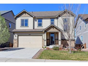 Charming two-story home with a well-maintained lawn, attached two-car garage, and attractive stone accents at 4783 S Wenatchee Cir, Aurora, CO 80015