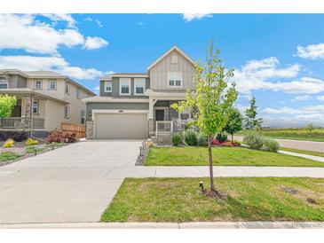 Charming two-story home featuring a well-maintained lawn and a two-car garage, perfect for suburban living at 2520 Canfield Ln, Erie, CO 80026