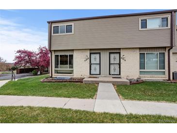 Charming townhome featuring a well-manicured lawn and lovely curb appeal with flowering tree at 4212 W Pondview Dr, Littleton, CO 80123